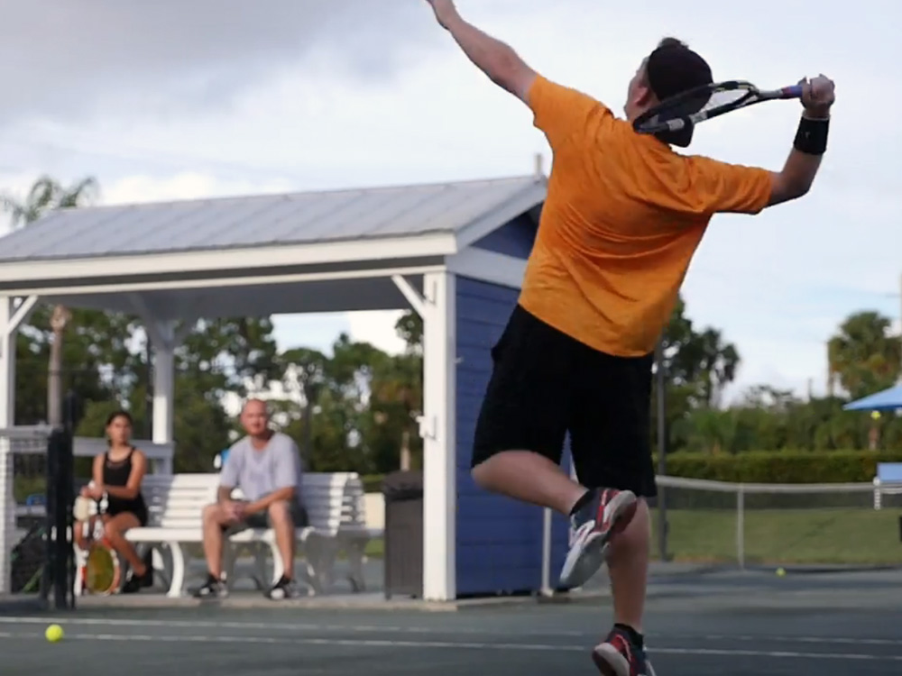 Junior Tennis Player in Stuart FL hitting overhead